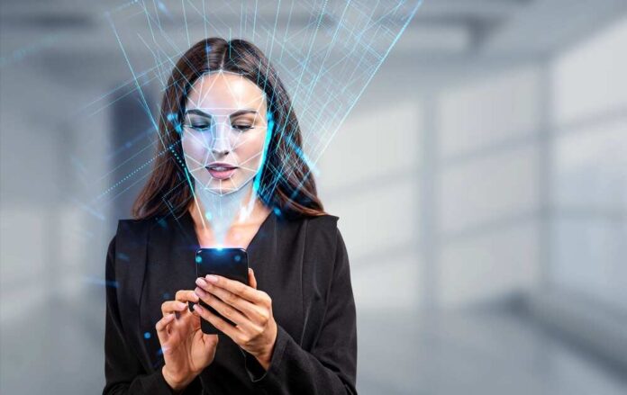 Businesswoman,With,Phone,In,Hands,,Biometric,Verification,And,Face,Detection. Shutterstock.com